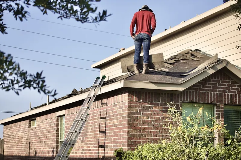 Professional roofer working on a residential roof in Westover Village